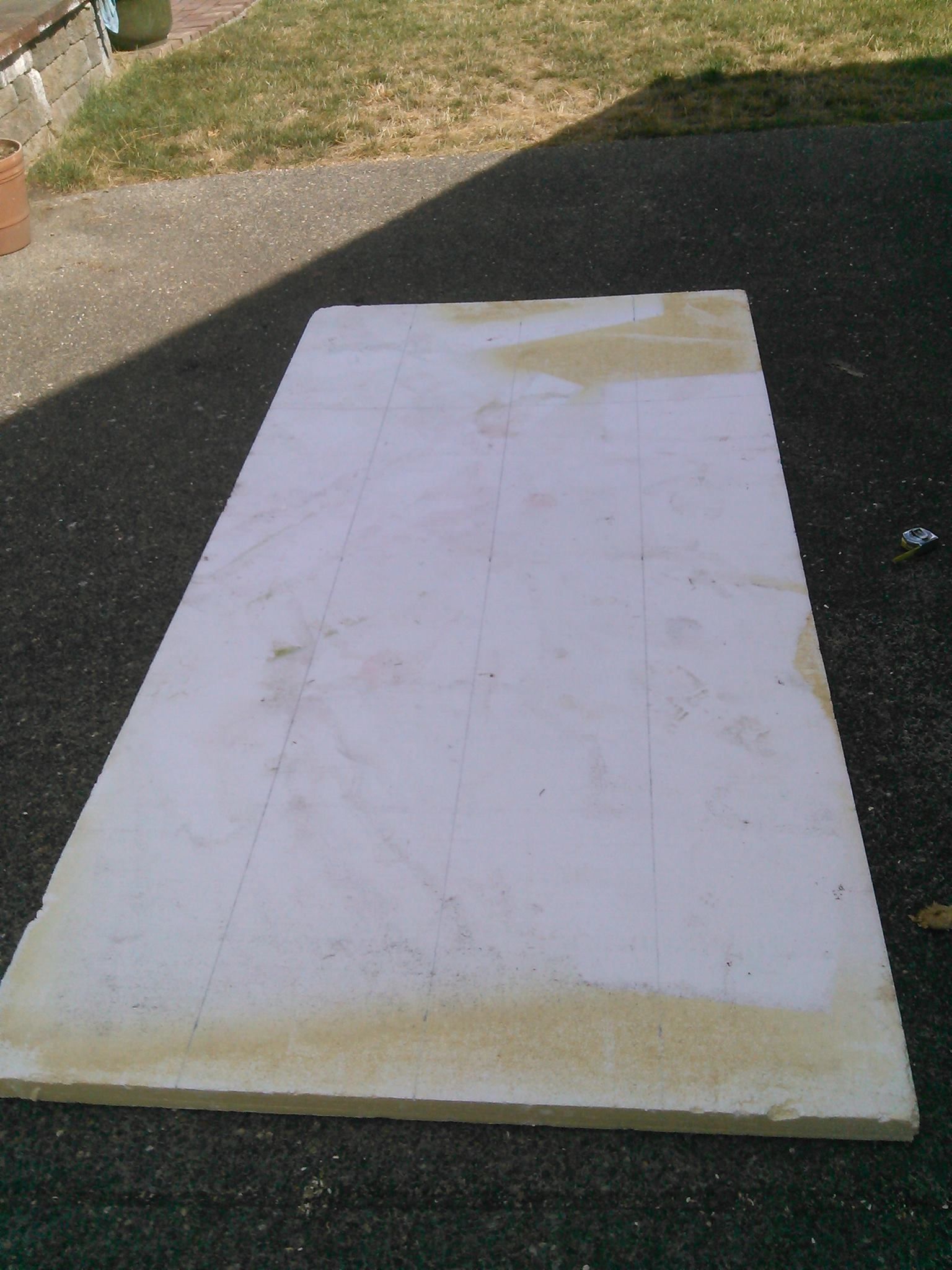 Measuring and cutting foam insulation board to size
