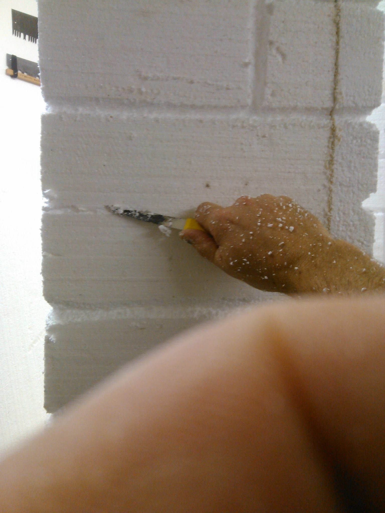 Carving brick grout lines into foam with a serrated knife
